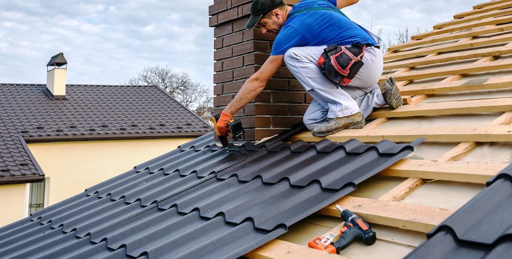 private roofer fixing tiles on roof